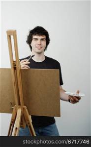 An image of a young man drawing a picture