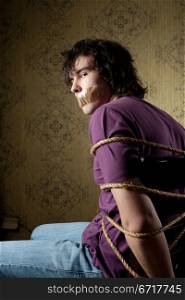 An image of a young tied man on a chair