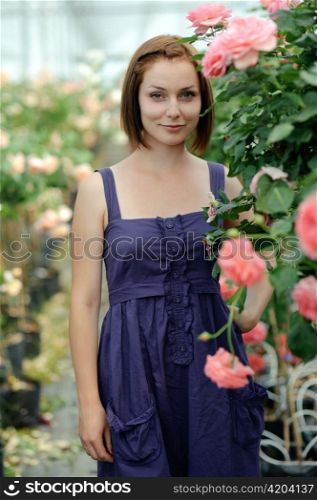 An image of a young woman in the greenhouse
