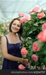 An image of a young woman in the greenhouse