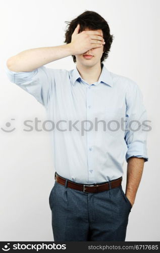 An image of a young worker with his hand on his eyes