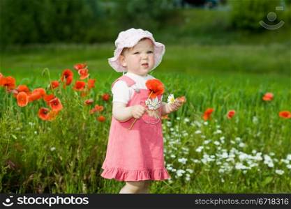 An image of baby-girl amongst field with red poppies