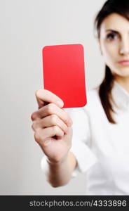 An image of beautiful woman showing red card