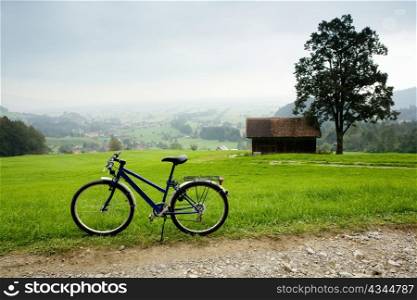 An image of bike near road in montains