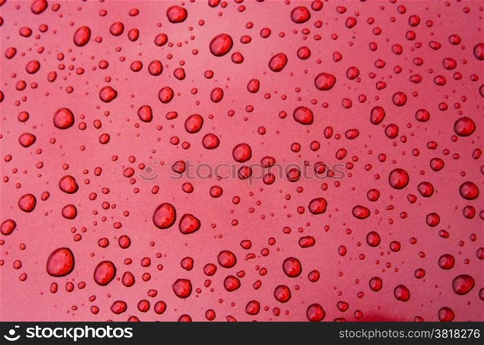 An image of drops on red background