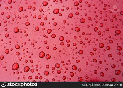 An image of drops on red background