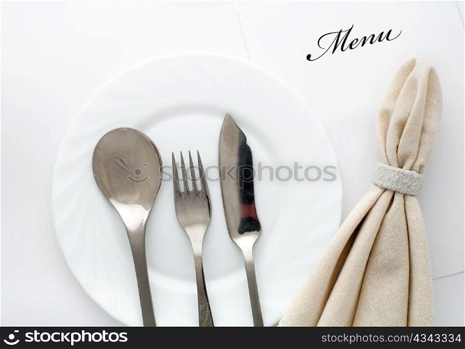 An image of fork, spoon and knife with napkin