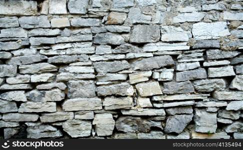 An image of grey stone wall. Close up.
