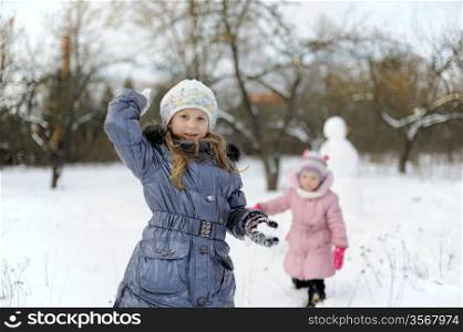 An image of little girls playing snowballs
