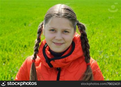 An image of little smile girl in green field