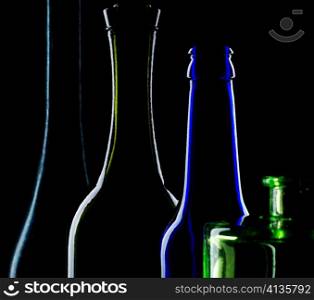 An image of necks of bottles on black background