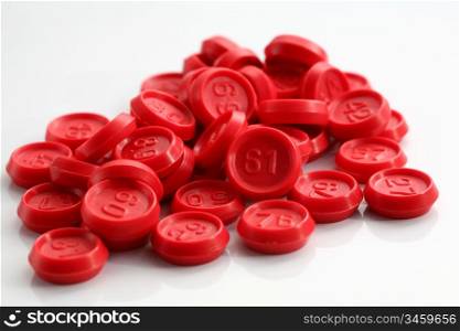 An image of red bingo game chips on white background