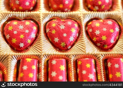 An image of red sweetmeats in golden box