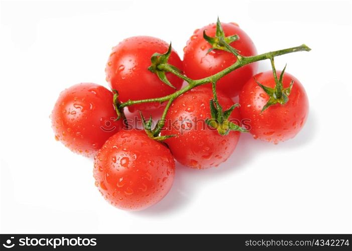 An image of red tomatoes with drops of water on them