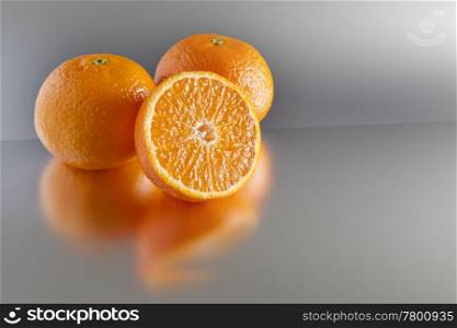 An image of three clementines on grey