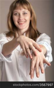 An image of woman in white shirt showing her hands