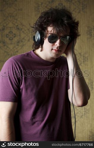 An image of young man listening to music in headphones