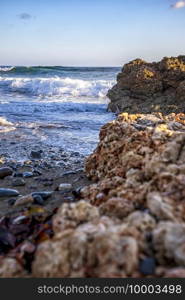 An incredible feeling at the shore of the Atlantic ocean with coral rocks. Vertical view