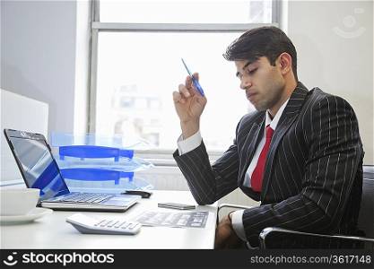 An Indian businessman working at office desk