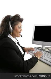 An Indian customer service representative at the computer wearing a headset. Isolated on white.