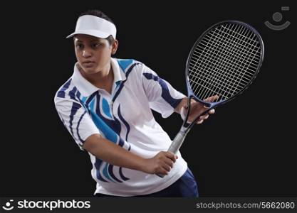An Indian female player playing tennis against black background