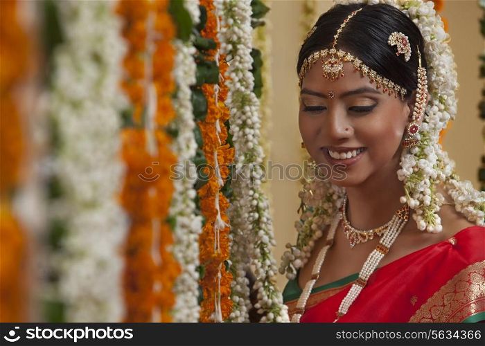 An Indian woman in traditional clothing smiling