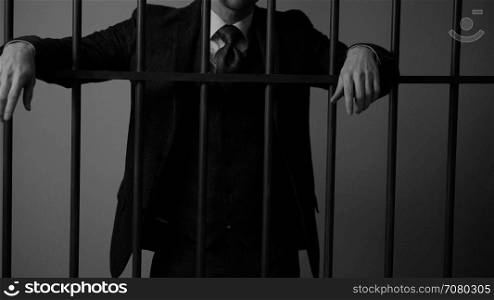 An insolent white collar criminal behind bars in prison