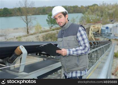 an inspector inspecting the conveyor