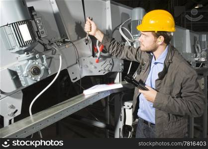 An installation mechanic workingon an industial conveyor belt