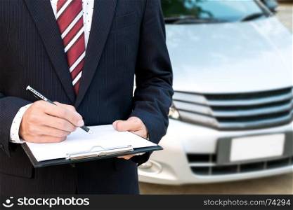 An insurance expert employee working with a car at the outdoor