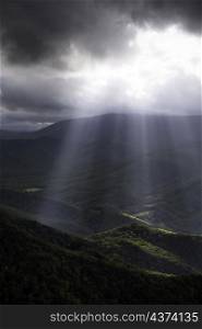An intense display of crepuscular rays of light illuminating down into the North Fork Valley of West Virginia as storm clouds moved off of the Allegheny Front to the west.