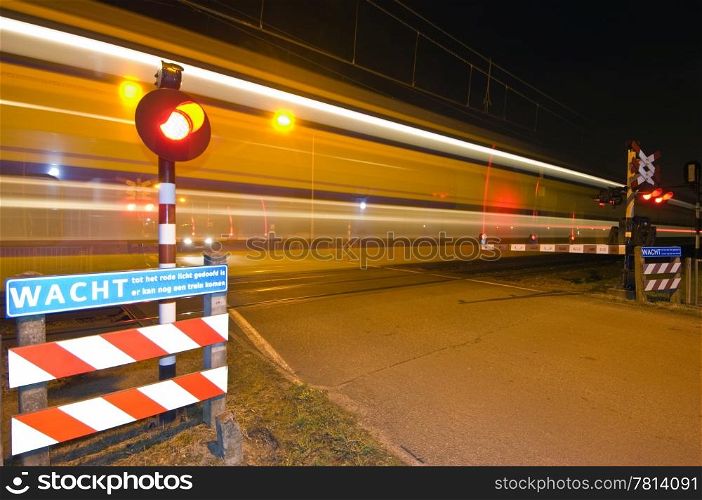 An intercity passing a railroad crossing at night