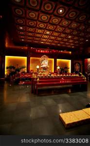 An interior of a buddhist temple with low lighting
