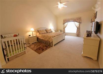 An interior shot of a master bedroom