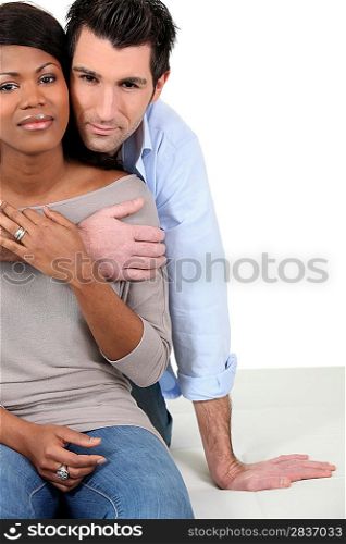An interracial couple embracing