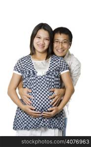 An isolated portrait of an expecting couple