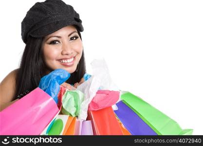 An isolated shot of a beautiful asian woman carrying shopping bags