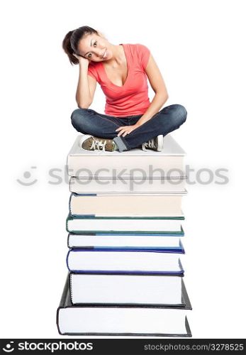 An isolated shot of a beautiful black college student sitting on a stack of books