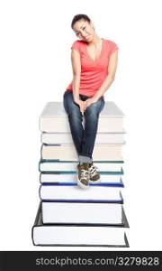 An isolated shot of a beautiful black college student sitting on a stack of books