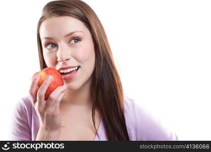 An isolated shot of a beautiful caucasian woman eating an apple
