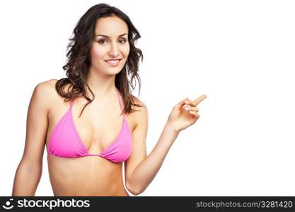 An isolated shot of a beautiful caucasian woman in bikini pointing