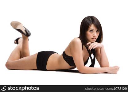 An isolated shot of a beautiful sexy asian girl in lingerie lying down on the floor