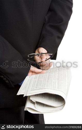 An isolated shot of a businessman carrying a financial newspaper, can be used as stock market or financial investment concept