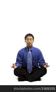 An isolated shot of a businessman meditating
