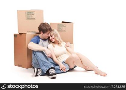 An isolated shot of a moving couple carrying boxes