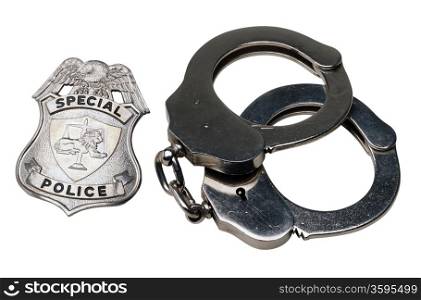 An isolated shot of a police badge and pair of handcuffs.