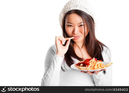 An isolated shot of an asian girl eating french fries