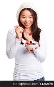 An isolated shot of an asian girl eating fruit