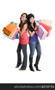 An isolated shot of two beautiful asian women carrying shopping bags