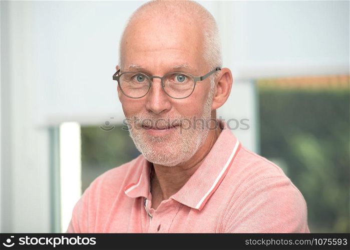 an mature senior man with pink shirt